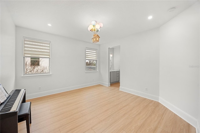 16689 Broadwater Ave, Winter Garden, FL 34787 - unfurnished room with a chandelier, light wood-style flooring, baseboards, and recessed lighting