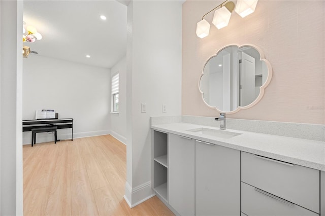 16689 Broadwater Ave, Winter Garden, FL 34787 - bathroom with baseboards, wood finished floors, recessed lighting, and vanity