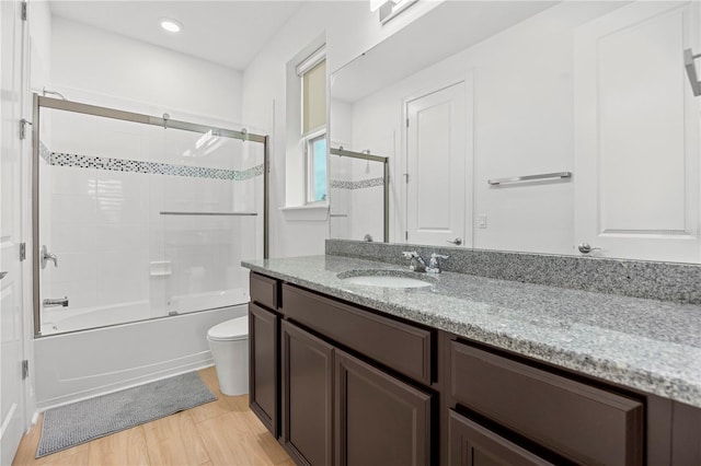 16689 Broadwater Ave, Winter Garden, FL 34787 - full bathroom featuring toilet, recessed lighting, wood finished floors, combined bath / shower with glass door, and vanity