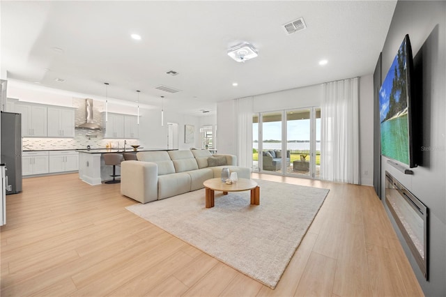16689 Broadwater Ave, Winter Garden, FL 34787 - living area with light wood-style flooring and recessed lighting