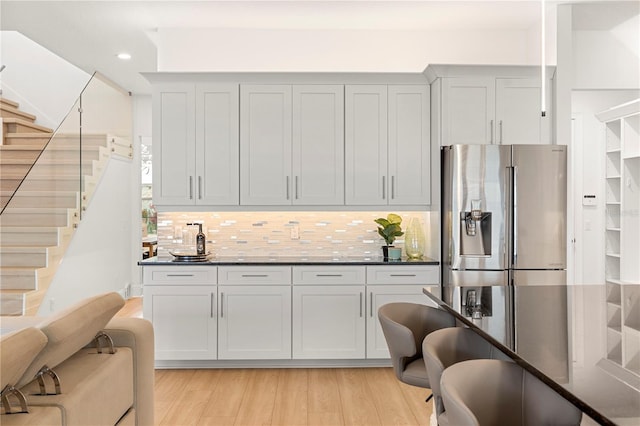 16689 Broadwater Ave, Winter Garden, FL 34787 - kitchen with stainless steel fridge with ice dispenser, light wood finished floors, tasteful backsplash, and recessed lighting