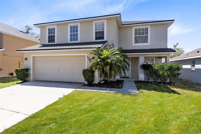 traditional-style home featuring a garage, driveway, a front yard, and stucco siding
