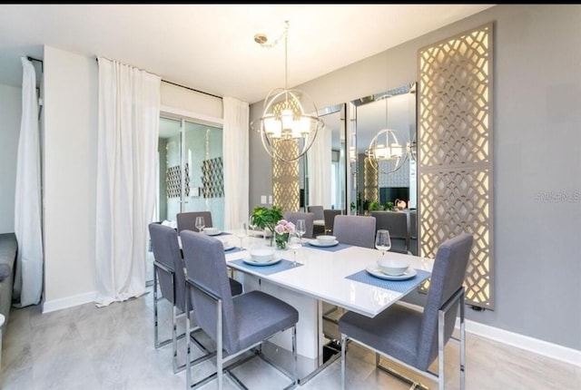 dining space featuring a notable chandelier and baseboards