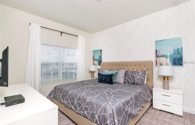 carpeted bedroom with wallpapered walls