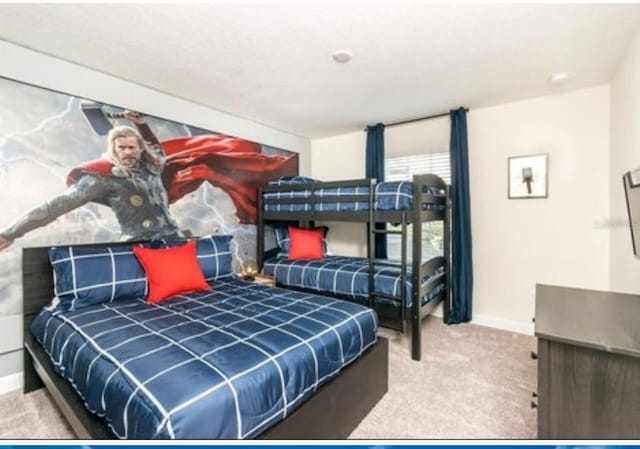carpeted bedroom featuring baseboards