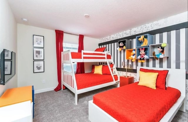 carpeted bedroom with a textured ceiling, wallpapered walls, and baseboards