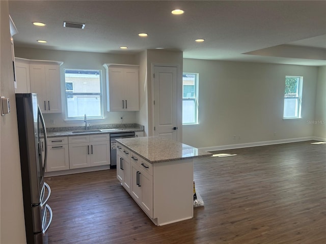 kitchen featuring recessed lighting, dark wood-type flooring, appliances with stainless steel finishes, and white cabinetry