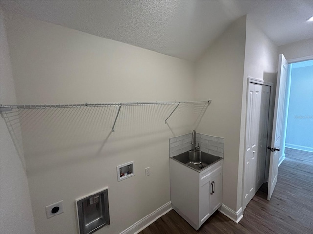 washroom featuring hookup for a washing machine, baseboards, hookup for an electric dryer, cabinet space, and dark wood-style flooring