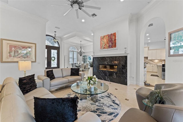 living room featuring ceiling fan with notable chandelier, ornamental molding, light tile patterned flooring, visible vents, and recessed lighting