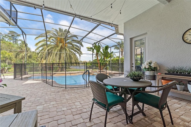 exterior space with a patio, a fenced in pool, and glass enclosure