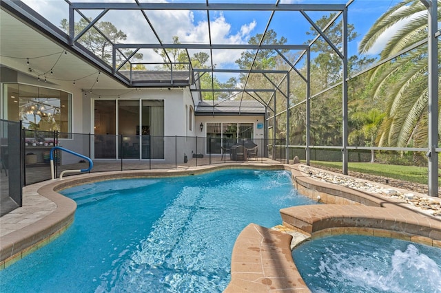 outdoor pool with an in ground hot tub, a patio, and a lanai