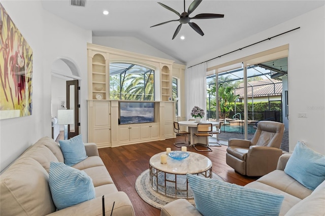 living room featuring dark wood finished floors, a ceiling fan, lofted ceiling, and a healthy amount of sunlight