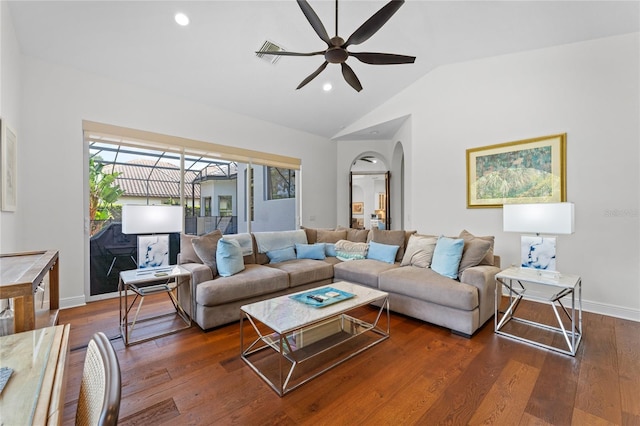 living area featuring a wealth of natural light, vaulted ceiling, ceiling fan, and arched walkways