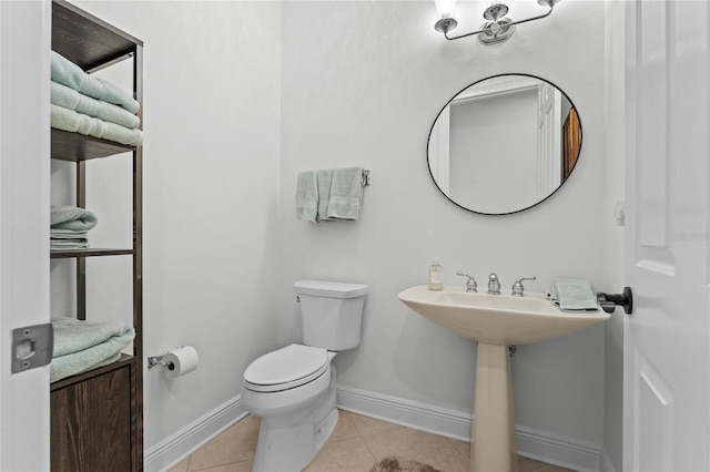 bathroom featuring tile patterned floors, toilet, and baseboards