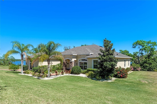 16752 Caravaggio Loop, Montverde, FL 34756 - rear view of property featuring stucco siding and a lawn