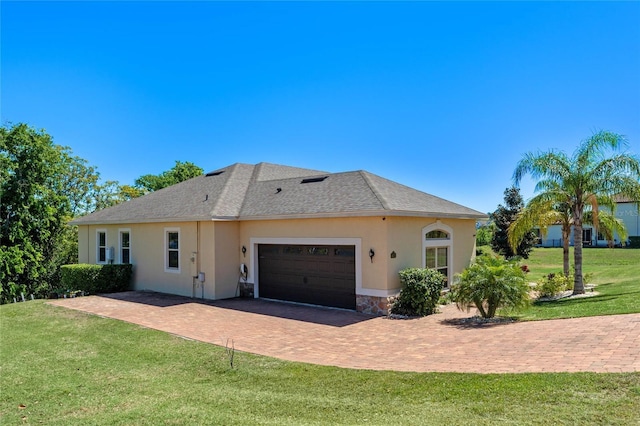 16752 Caravaggio Loop, Montverde, FL 34756 - view of front of home featuring a garage, stucco siding, a front lawn, and decorative driveway