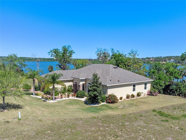 16752 Caravaggio Loop, Montverde, FL 34756 - view of front of house with a front lawn, a water view, and stucco siding