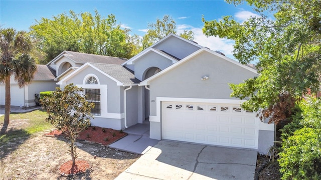 6921 Blair Dr, Orlando, FL 32818 - single story home featuring stucco siding, concrete driveway, a garage, and a shingled roof