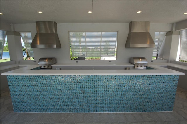18381 Oliver Twist Way, Winter Garden, FL 34787 - kitchen featuring recessed lighting, a textured ceiling, and wall chimney exhaust hood