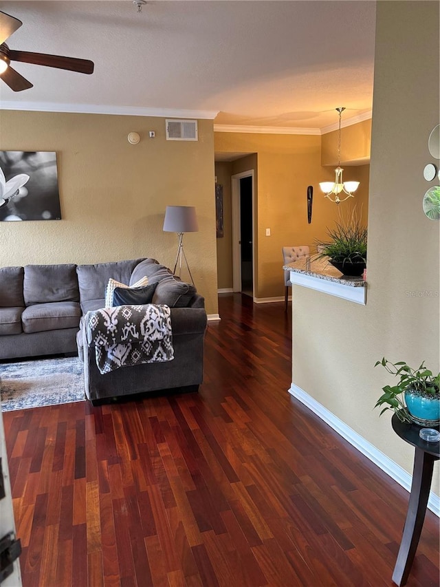 living area featuring visible vents, crown molding, baseboards, ceiling fan, and wood finished floors