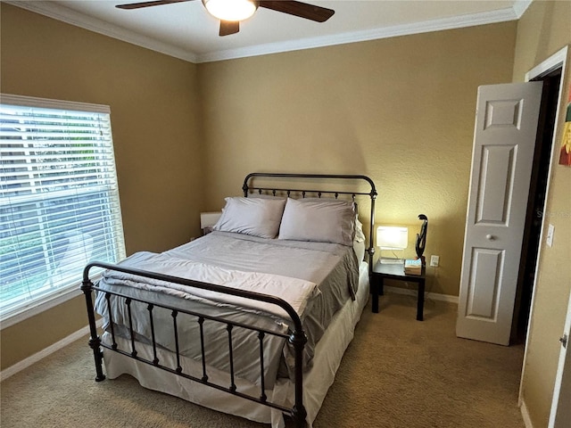 carpeted bedroom featuring multiple windows, a ceiling fan, baseboards, and ornamental molding