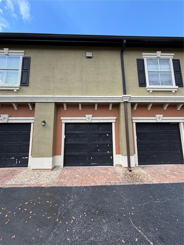 view of front of house with stucco siding and an attached garage