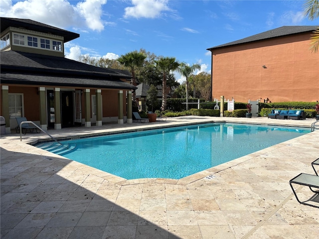 community pool featuring outdoor lounge area and a patio area