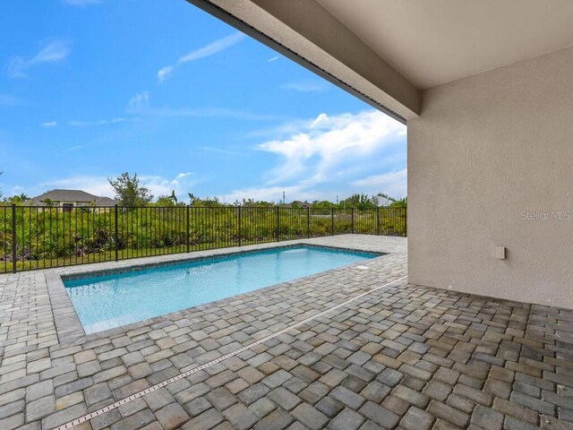 view of swimming pool with a patio area, fence private yard, and a fenced in pool