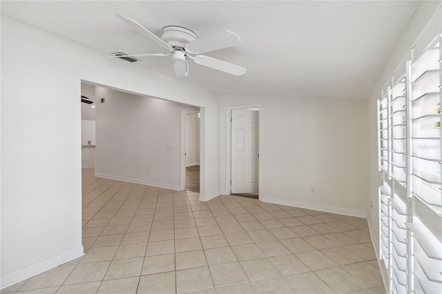 unfurnished room with visible vents, a ceiling fan, baseboards, and light tile patterned flooring