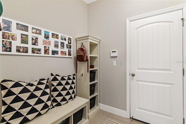 mudroom with light tile patterned floors and baseboards