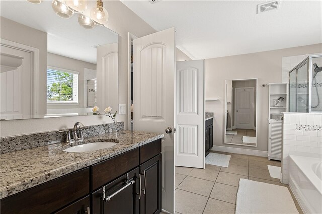 full bath featuring tile patterned floors, visible vents, a garden tub, a stall shower, and vanity