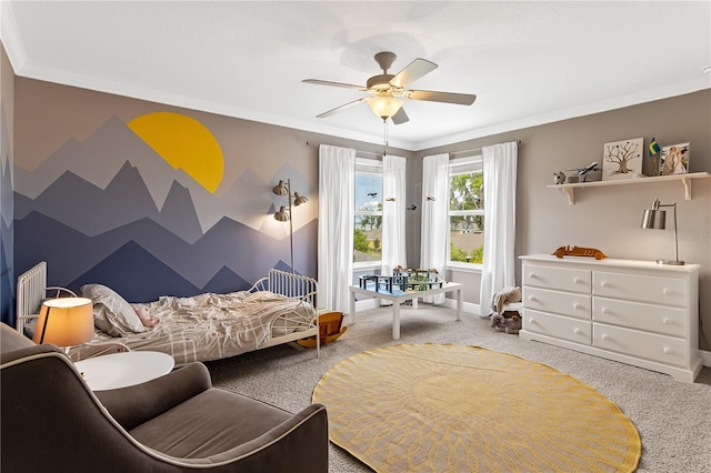 bedroom featuring an accent wall, carpet flooring, baseboards, and ornamental molding