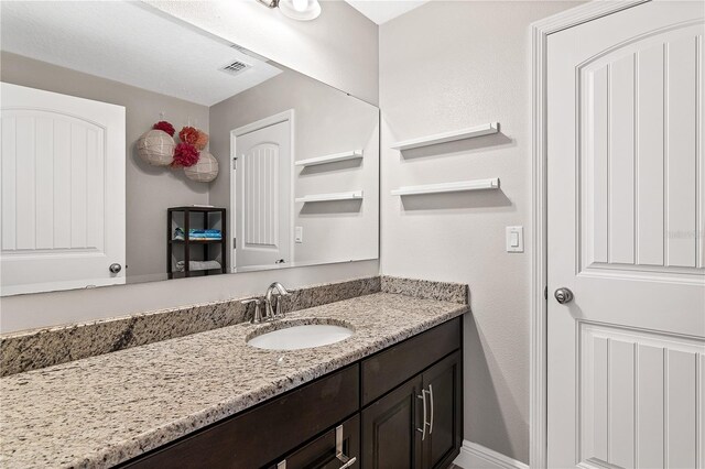 bathroom with visible vents and vanity