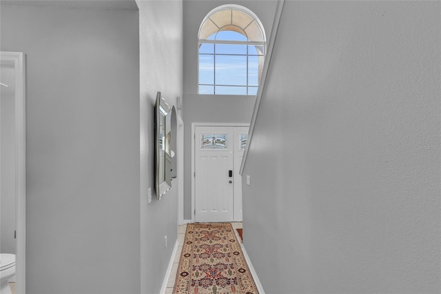 122 Carmel Bay Dr, Sanford, FL 32771 - doorway to outside featuring a high ceiling and baseboards