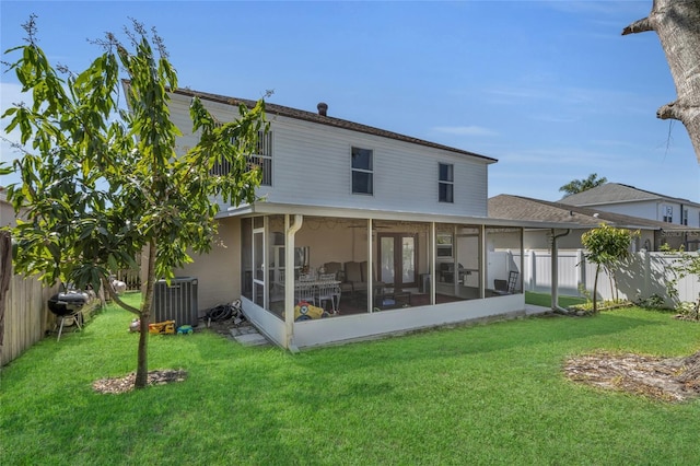 122 Carmel Bay Dr, Sanford, FL 32771 - back of property featuring cooling unit, a lawn, a fenced backyard, and a sunroom