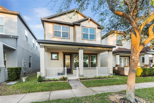 view of front of home with a porch and a front lawn
