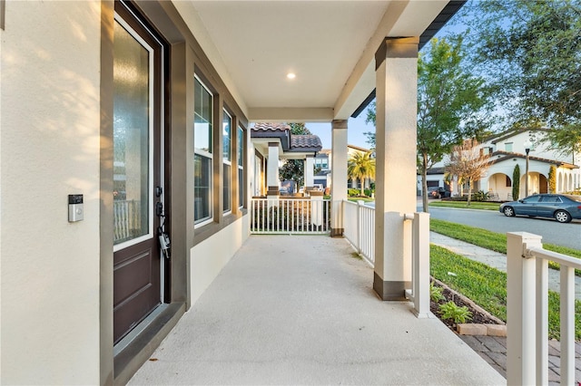 view of patio / terrace with a residential view and a porch