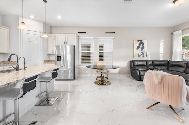 living area featuring recessed lighting, visible vents, baseboards, and marble finish floor