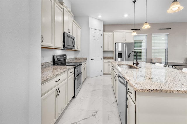 kitchen featuring light stone countertops, an island with sink, a sink, appliances with stainless steel finishes, and marble finish floor