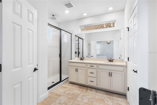 full bath featuring a sink, visible vents, double vanity, and a shower stall