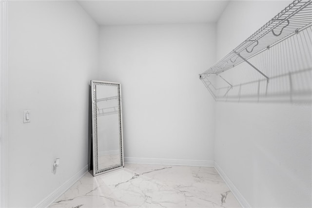 spacious closet featuring marble finish floor