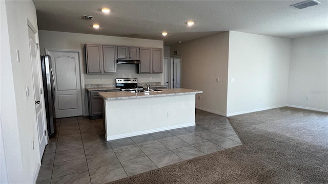2597 Shamrock St, Tavares, FL 32778 - kitchen with visible vents, gray cabinets, stainless steel appliances, and dark carpet