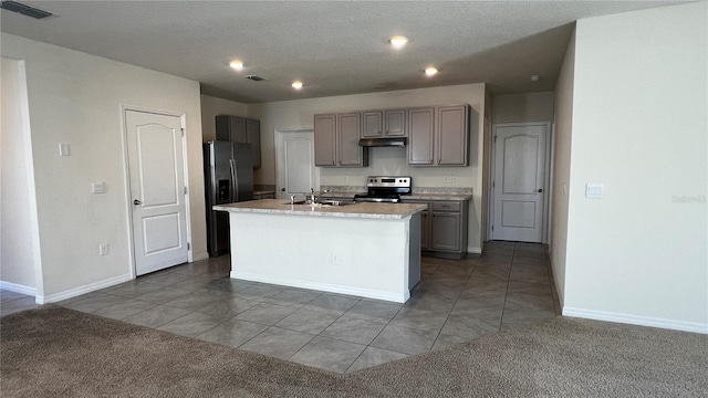 2597 Shamrock St, Tavares, FL 32778 - kitchen featuring visible vents, under cabinet range hood, carpet floors, stainless steel appliances, and a sink
