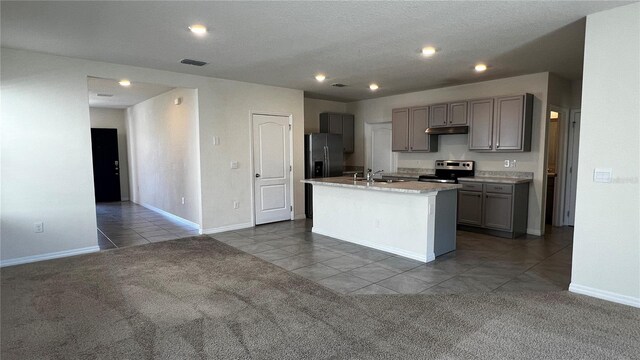 2597 Shamrock St, Tavares, FL 32778 - kitchen featuring visible vents, carpet floors, a sink, under cabinet range hood, and appliances with stainless steel finishes