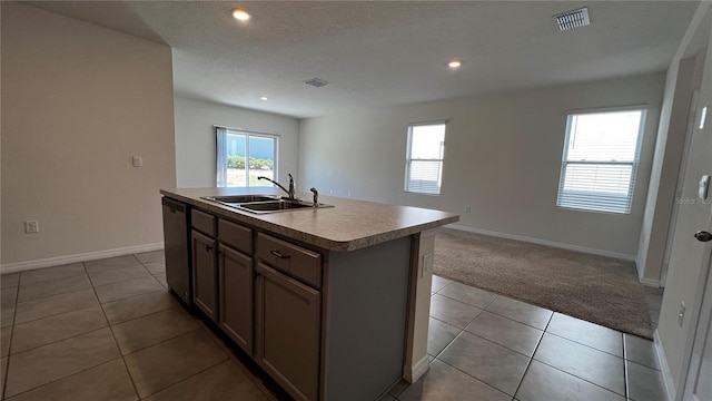 2597 Shamrock St, Tavares, FL 32778 - kitchen with visible vents, a sink, carpet flooring, tile patterned floors, and stainless steel dishwasher