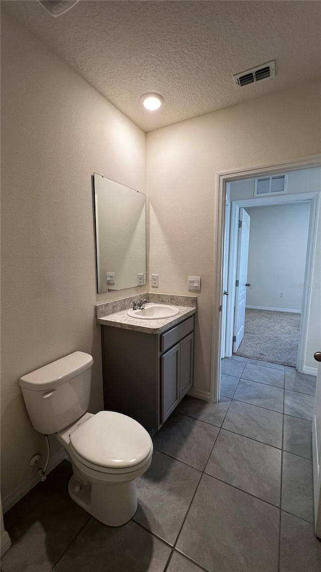 2597 Shamrock St, Tavares, FL 32778 - bathroom featuring tile patterned floors, visible vents, toilet, a textured ceiling, and vanity