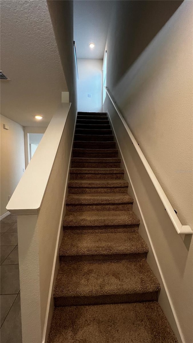 2597 Shamrock St, Tavares, FL 32778 - stairs with visible vents and a textured ceiling