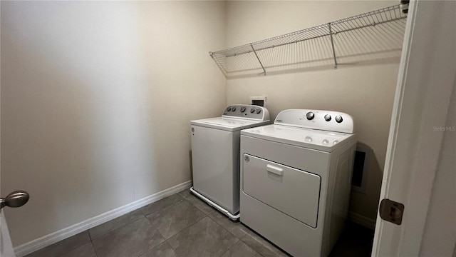 2597 Shamrock St, Tavares, FL 32778 - laundry room featuring laundry area, washing machine and dryer, baseboards, and dark tile patterned flooring