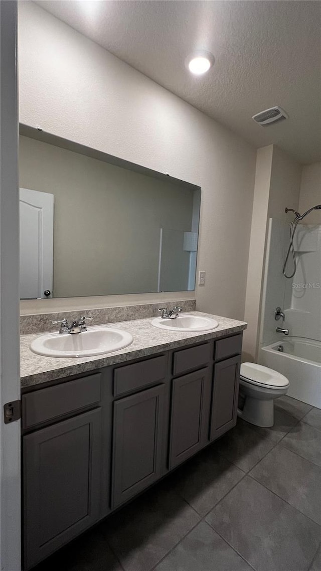2597 Shamrock St, Tavares, FL 32778 - bathroom featuring a sink, toilet, tub / shower combination, and double vanity