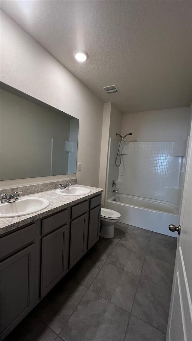 2597 Shamrock St, Tavares, FL 32778 - bathroom featuring double vanity, shower / washtub combination, toilet, and a sink